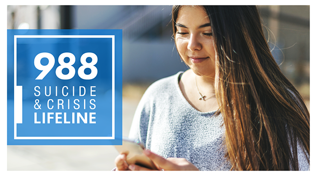 988 Suicide & Crisis Lifeline; Young woman with long hair look at her mobile device.