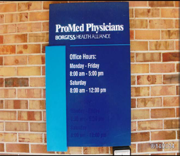 A close-up photo of the blue sign in the previous photo with white text: 1st line, ProMed Physicians (large text); 2nd line, BORGESS HEALTH ALLIANCE (smaller text); and 3rd-7th lines,  Office Hours: Monday – Friday 8:00 am – 5:00 pm, Saturday 8:00 am – 12:00 pm.