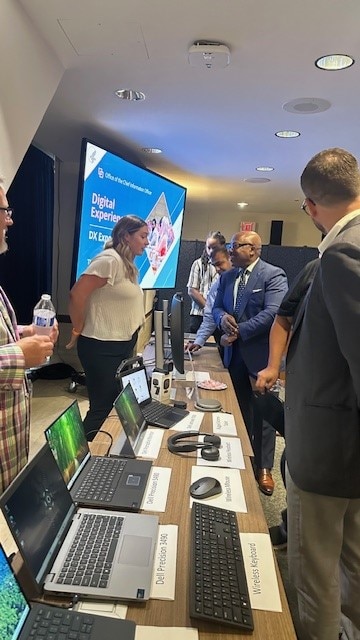 Staff viewing some of the new technology projects at one of the booths