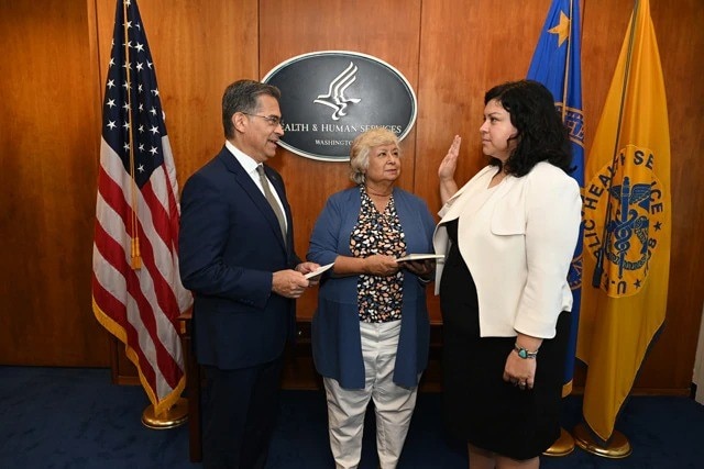 HHS Secretary Xavier Becerra pictured with OCR Director Melanie Fontes Rainer and her mother.